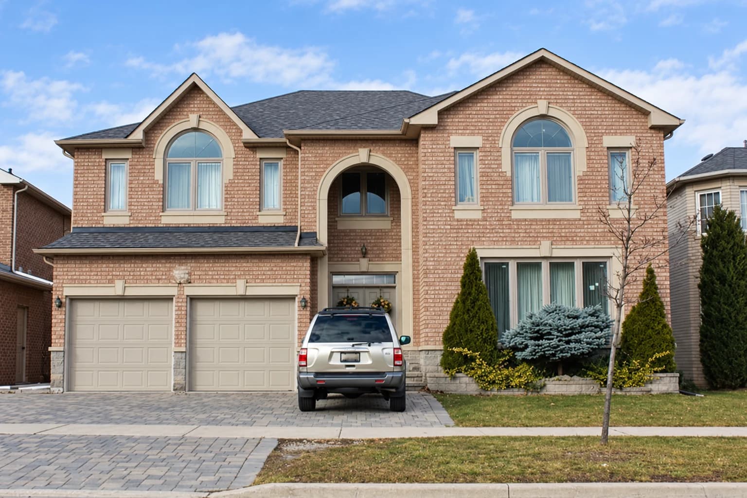 Brick home with arched upper windows and a recessed front entrance