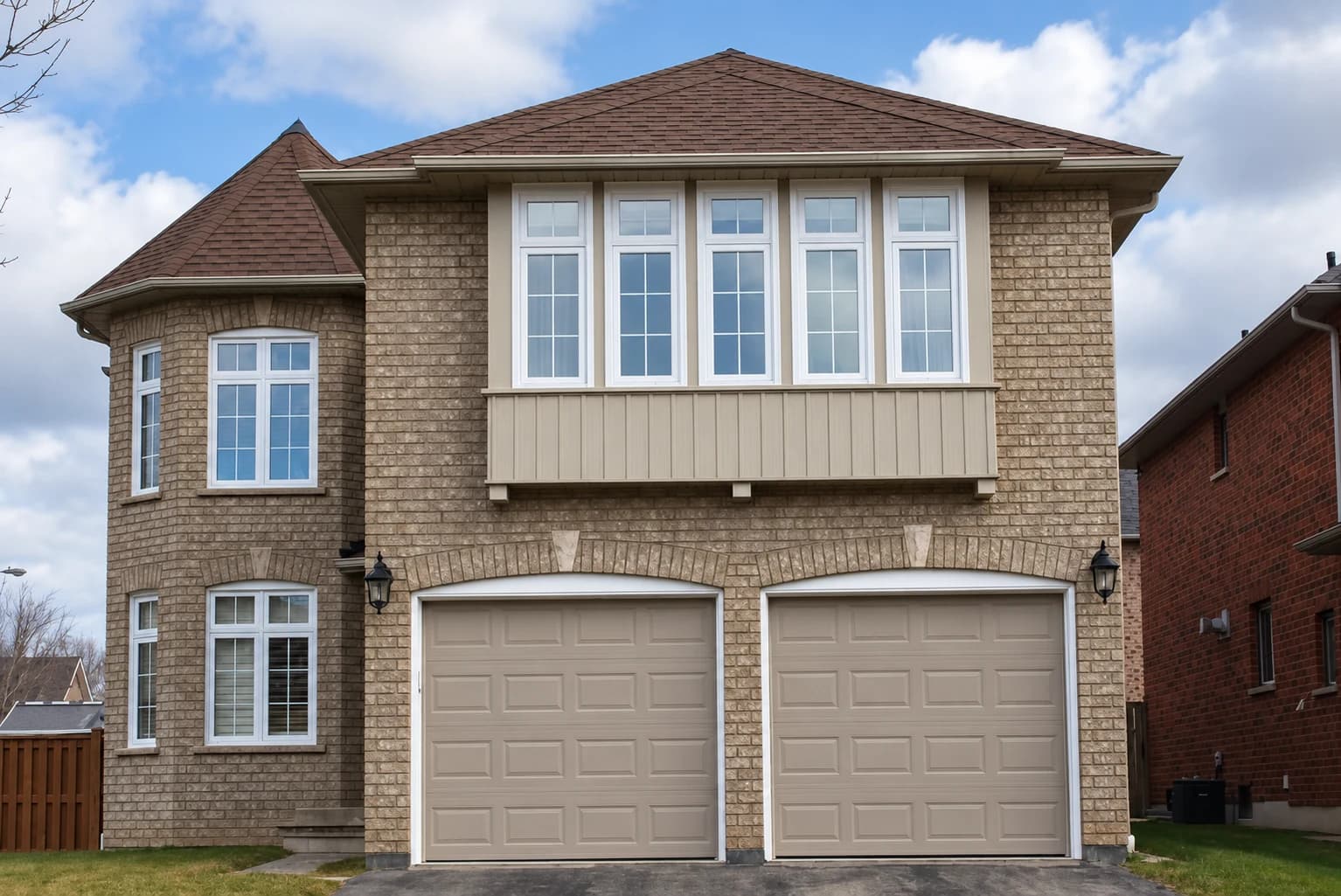 Two-storey brick home with white bay windows and a double garage