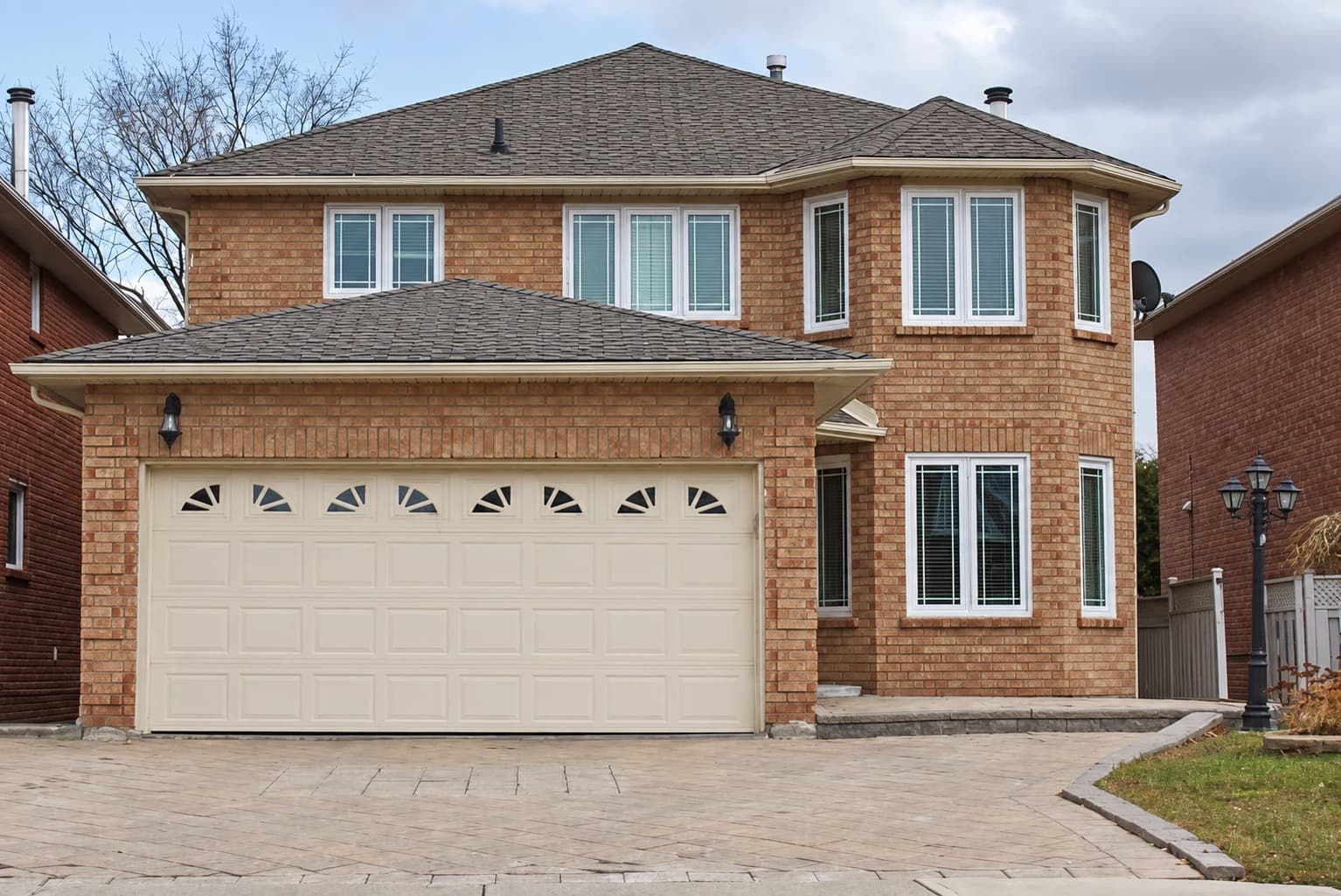 Brick home with white-framed casement and bay windows